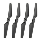 Four black drone propellers with mounting hubs