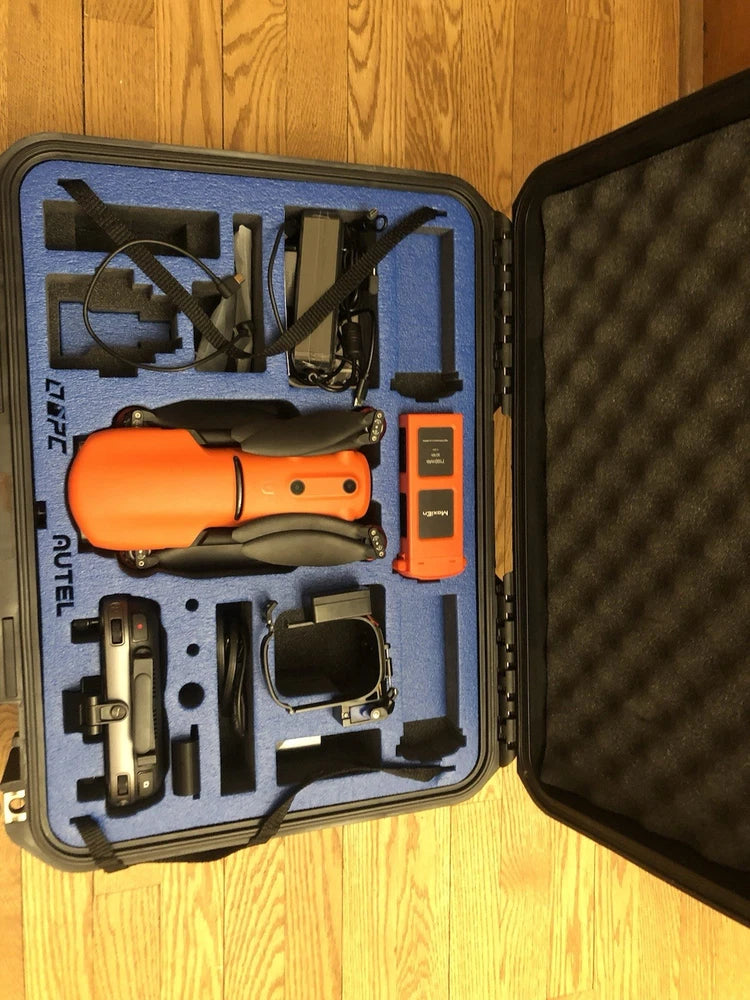 Rugged drone carrying case with orange drone and controller components inside