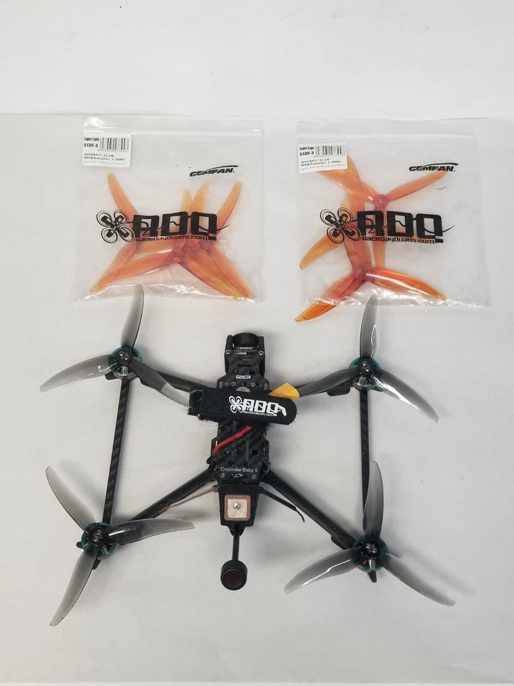 GEPRC Crocodile Baby 5 drone with four orange propellers and FPV camera module