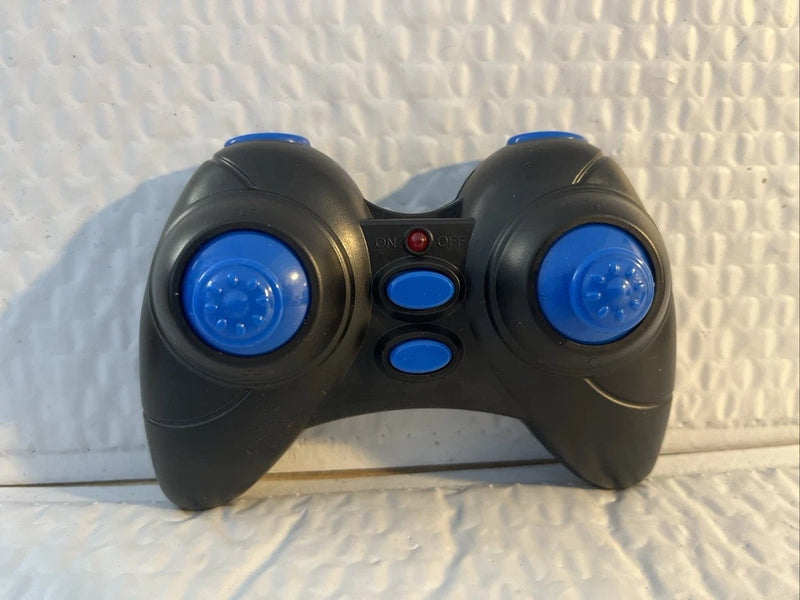 Black RC controller remote with blue thumbsticks and three blue buttons