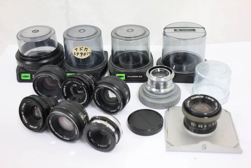 Assorted set of black camera lenses with caps and one silver lens mount