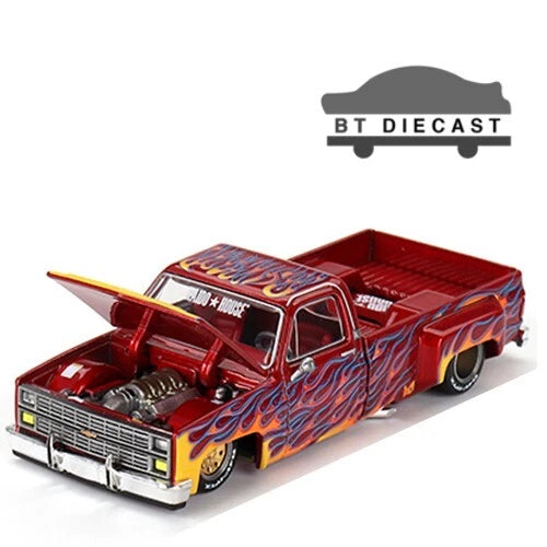 Red flame graphic die-cast pickup truck with open hood and visible engine