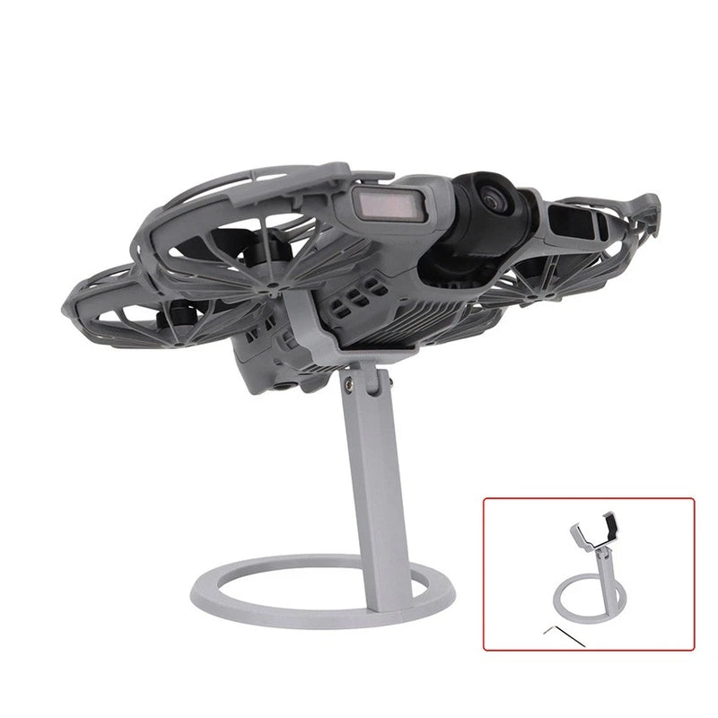 Desktop drone display stand with black cradle and gray circular base for mounting