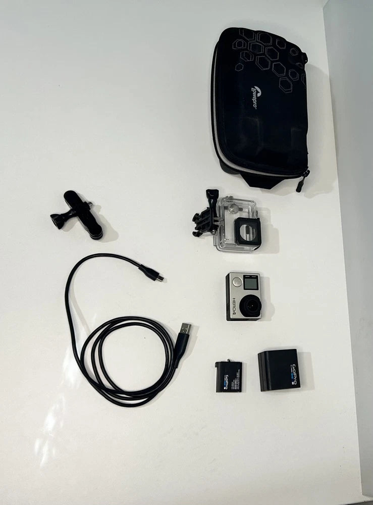 GoPro HERO4 action camera kit with waterproof case, mounts, cable, and memory cards