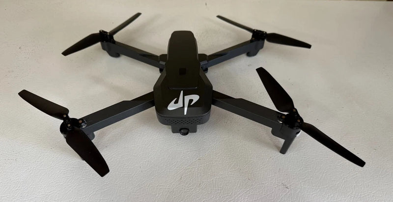 Black folding quadcopter drone with four propellers and front controller module