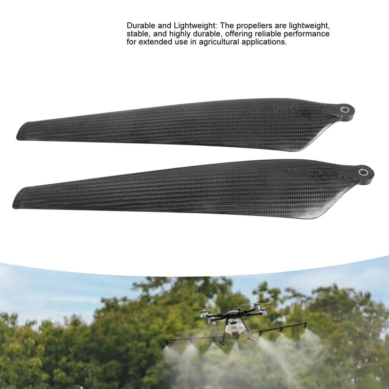Pair of dark carbon fiber folding propellers with circular mounting holes
