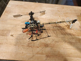 RC helicopter toy with black frame, rotor blades, and visible components