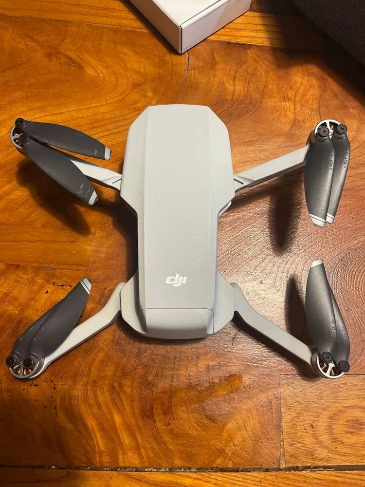 DJI drone with white body and four black propellers