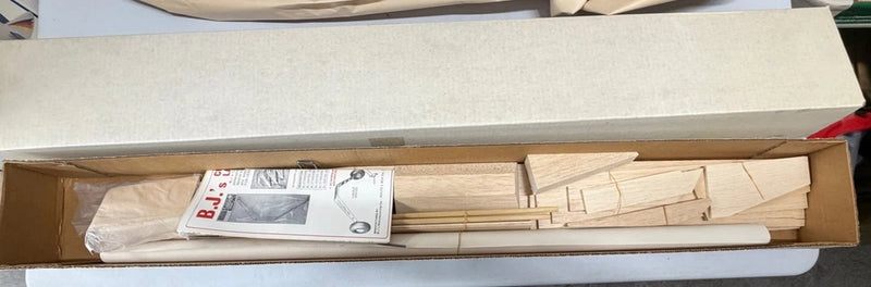 Vintage RC sport airplane kit box with balsa wing and fuselage parts