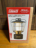 Coleman metallic camping battery lantern with handle and glass panels, dark base