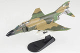 Camouflage F-4C Phantom II model aircraft on black display stand