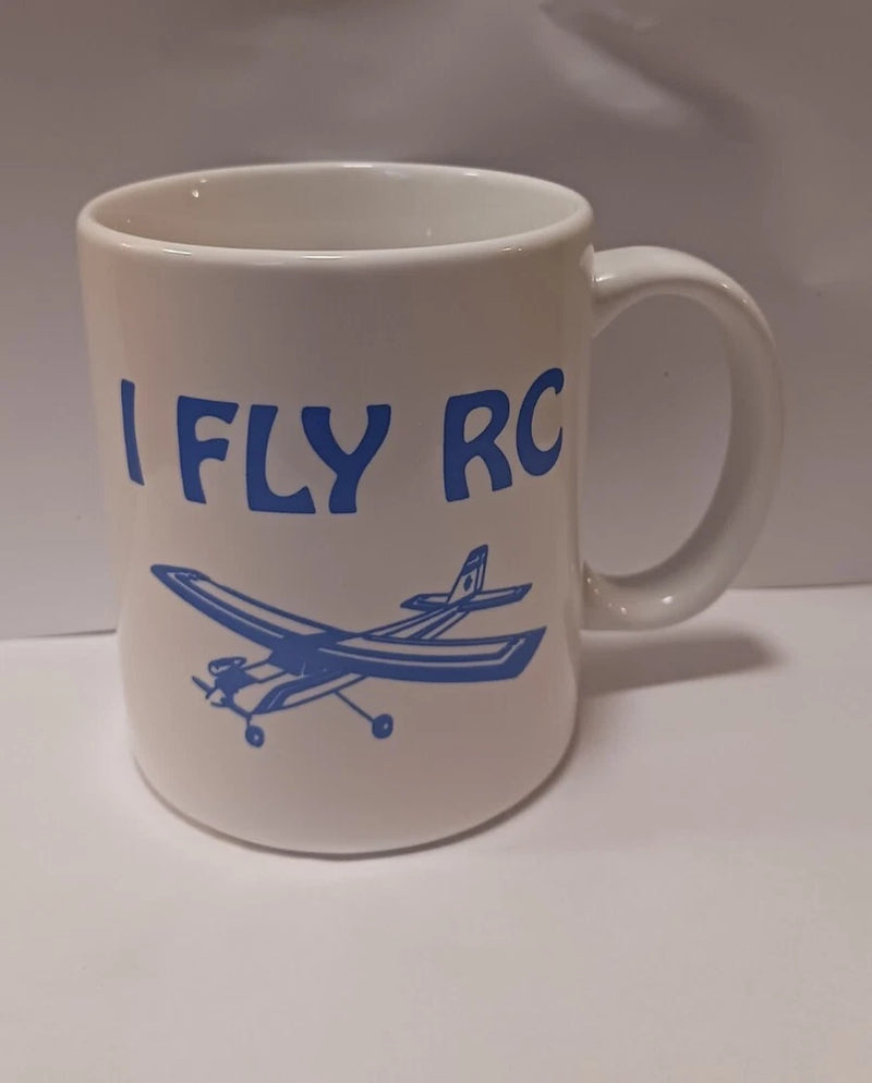 White coffee mug with blue "I FLY RC" text and airplane graphic