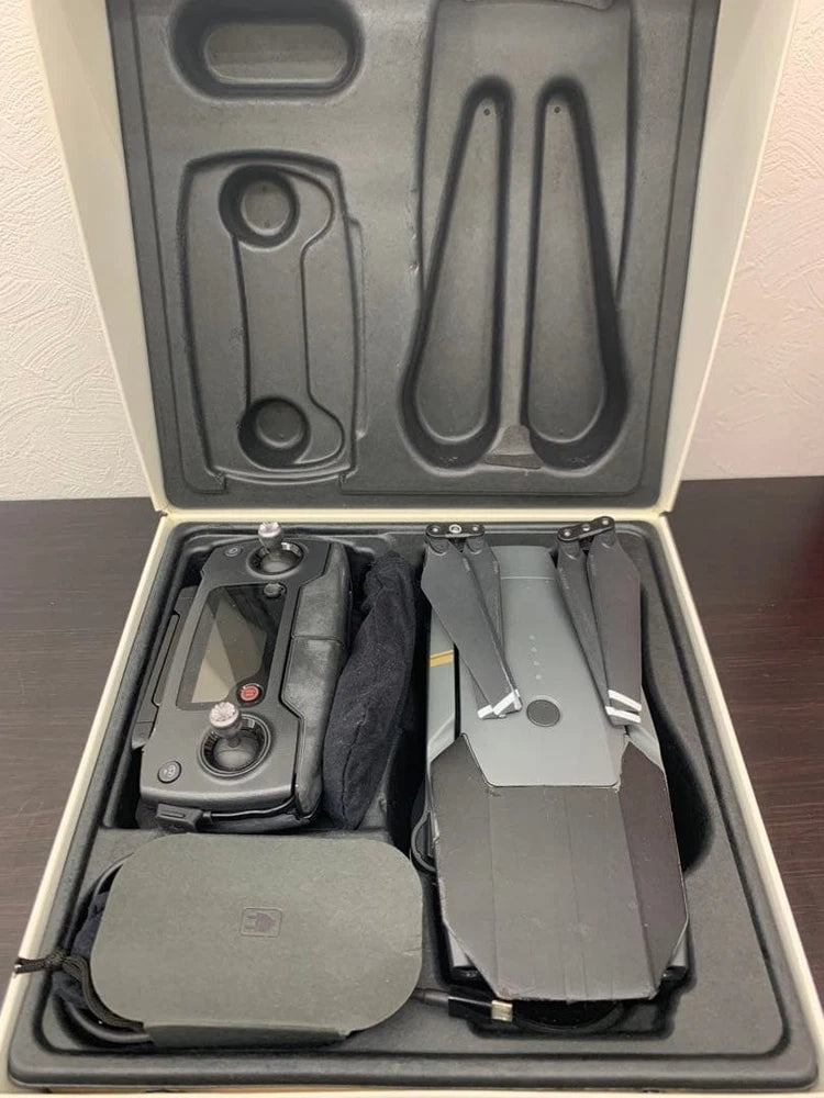 Gray DJI Mavic Pro drone in hard case with propellers and cables