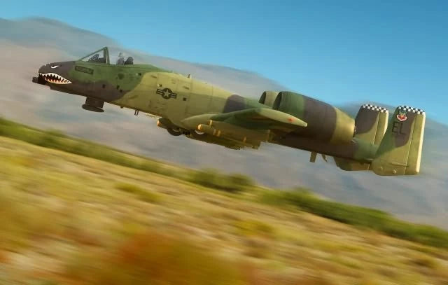 Green military jet aircraft model in flight, side view
