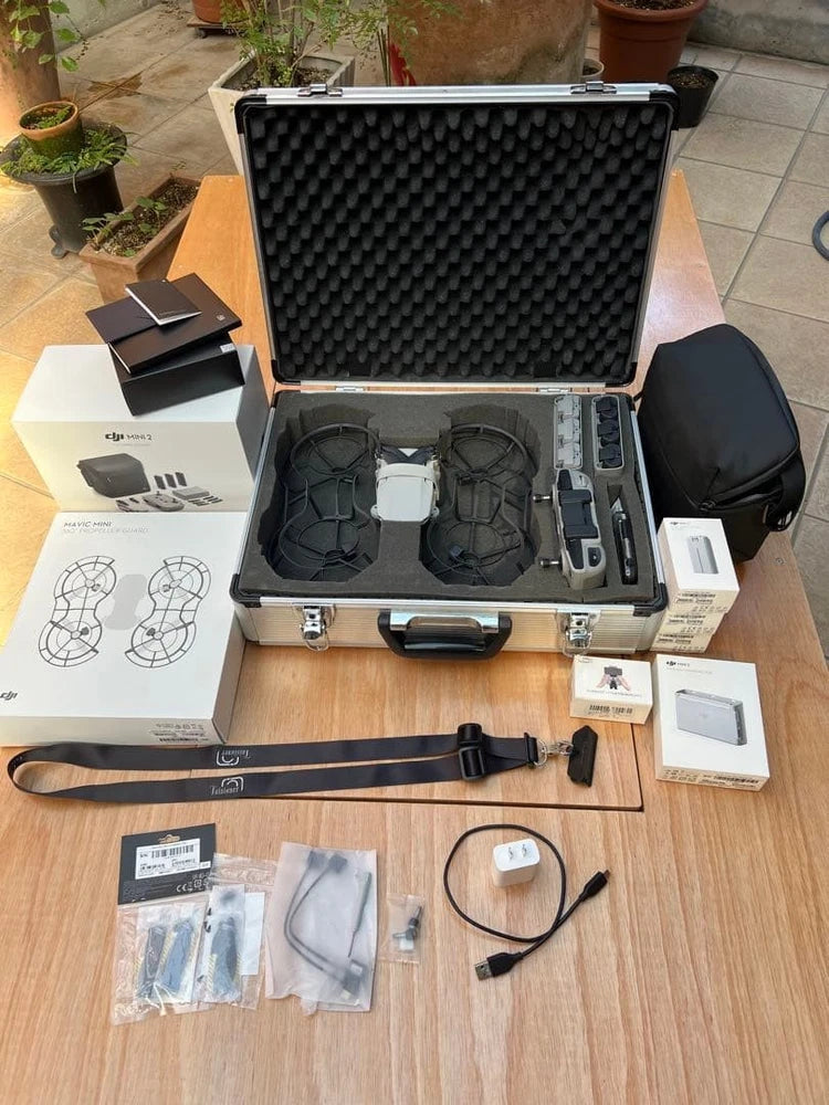 Portable drone accessory kit in open hard case with drone, propellers, and cables