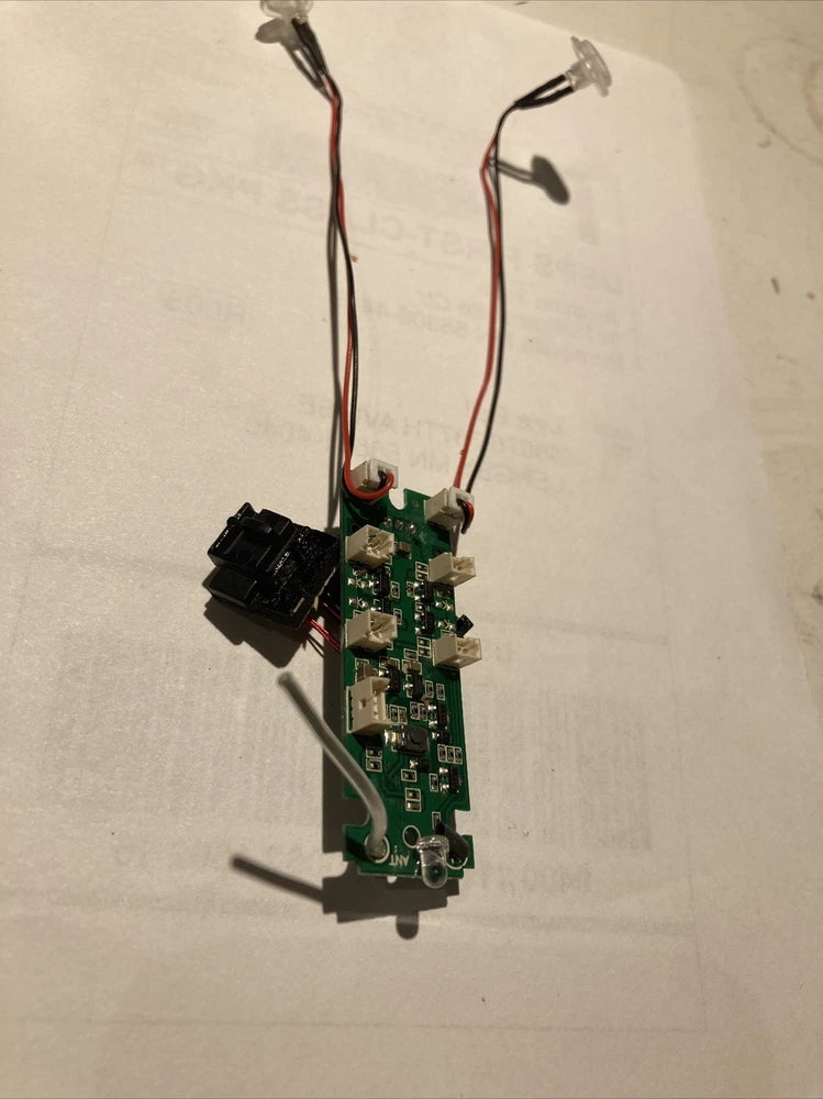 Drone receiver circuit board with wiring harness and connector ports, green PCB