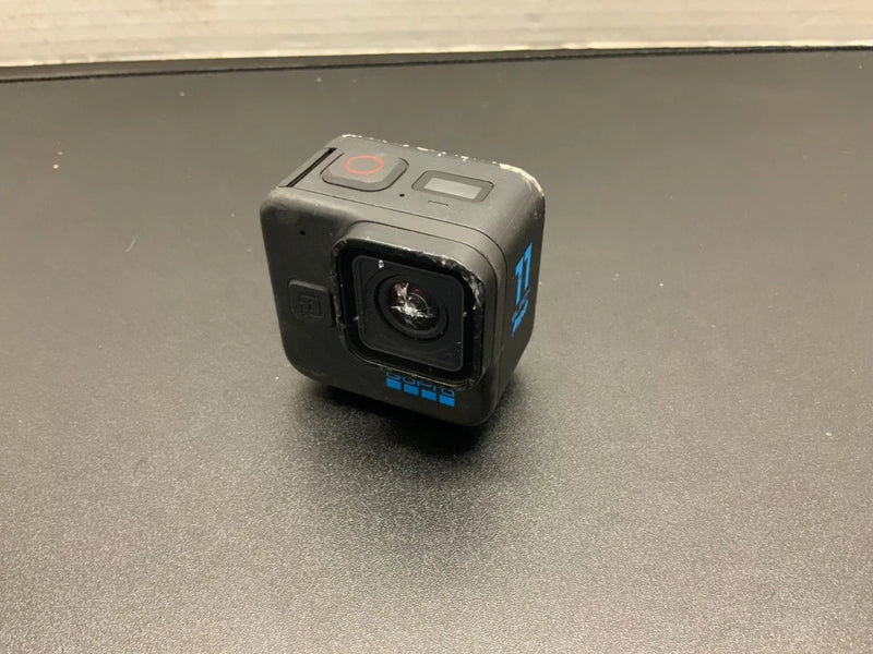 GoPro mini action camera, black body with front lens and side buttons