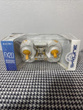 Mini quadcopter drone in clear retail box, yellow knobs and prop arms