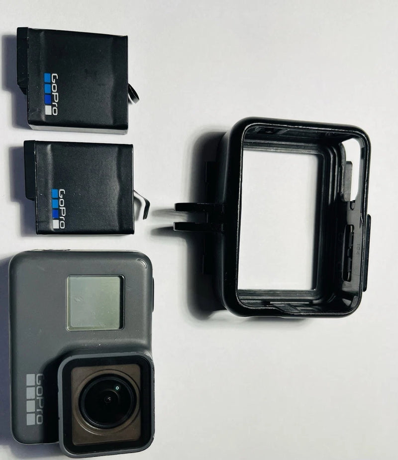 GoPro HERO5 action camera with waterproof housing and lens, plus two battery packs