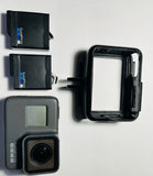 GoPro HERO5 action camera with waterproof housing and lens, plus two battery packs
