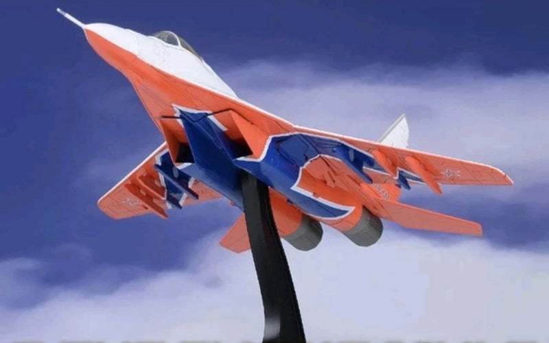 1:72 MiG-29 model aircraft, orange and blue aerobatic livery on stand