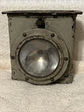 Military lantern with square metal housing and round clear glass lens