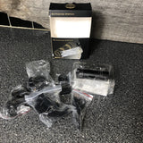 Mini sports action camera kit with black camera body and accessories in plastic bags