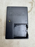 Olympus LI-50C battery charger with open charging bay, black case