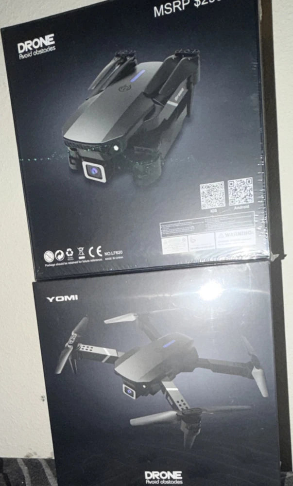 Foldable quadcopter drone in black, shown on retail box with camera icon