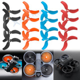 Set of spare drone propeller blades: black, orange, blue, and red.