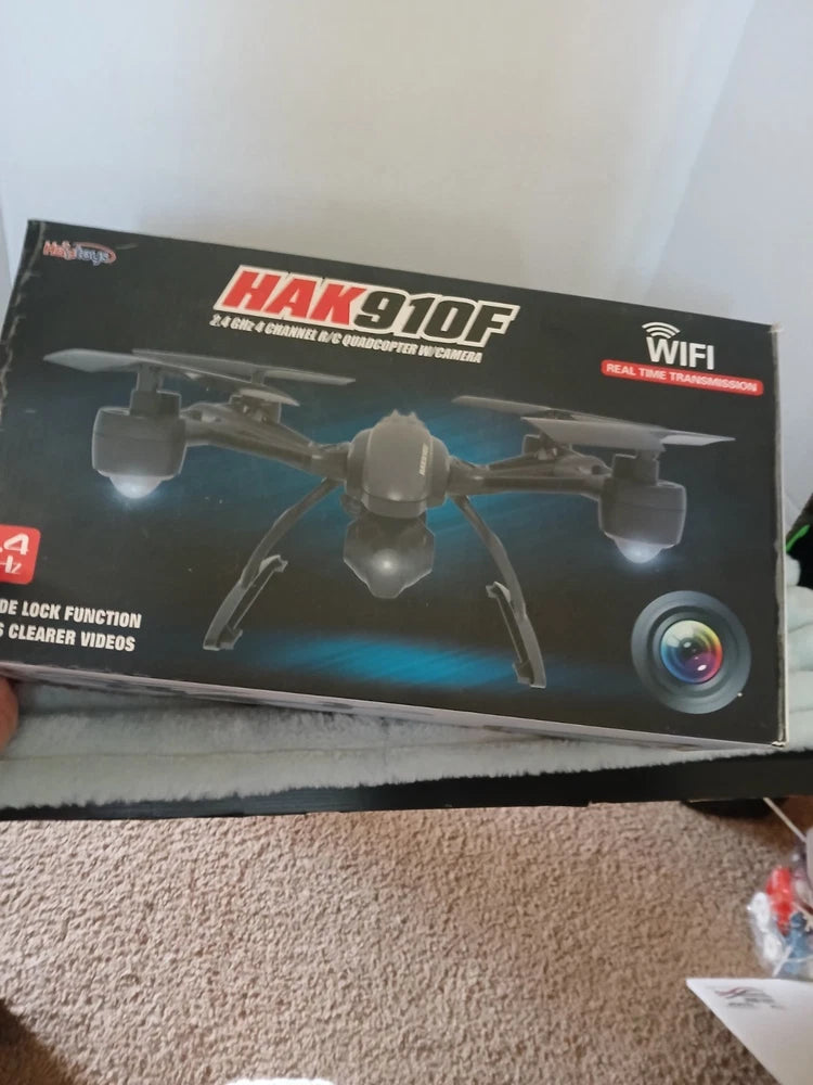 Drone quadcopter parts box with HAK910F branding, WiFi label, camera lens graphic