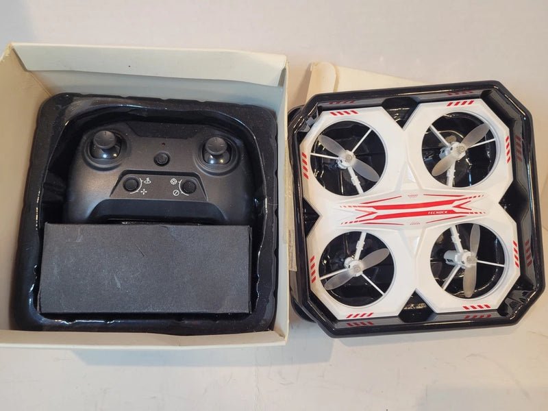 Remote-controlled LED drone and controller in open box, white drone with four propellers