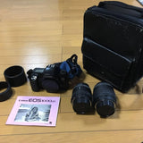 Canon EOS 1000QD film camera with two zoom lenses and black carrying case