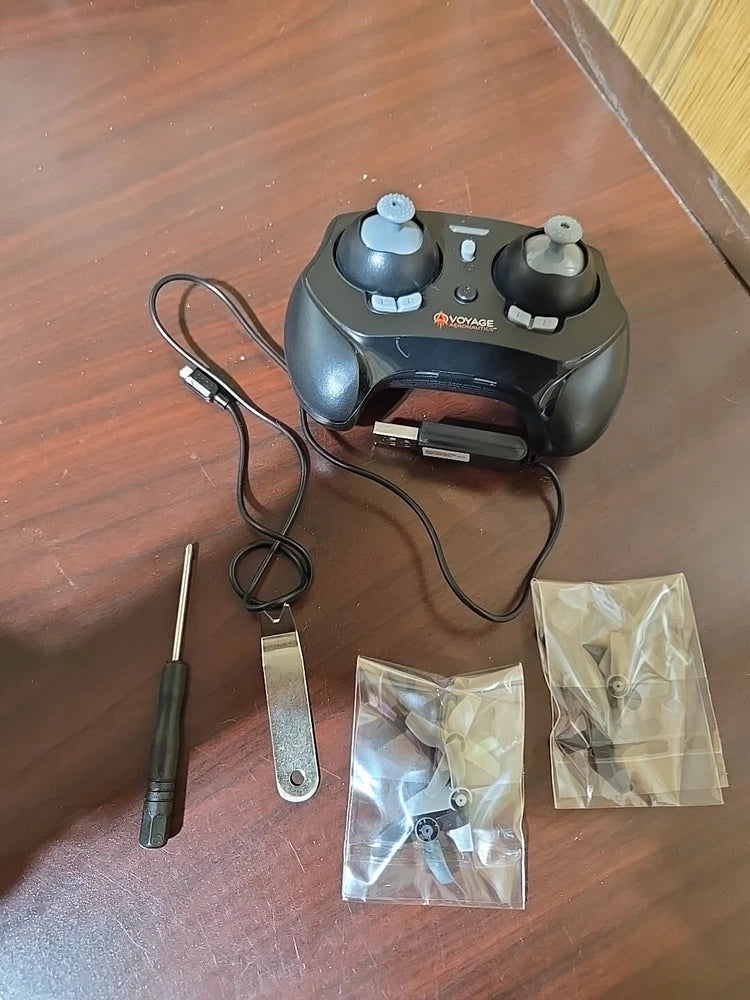 Palm-sized mini drone remote controller with spare prop parts and small tool