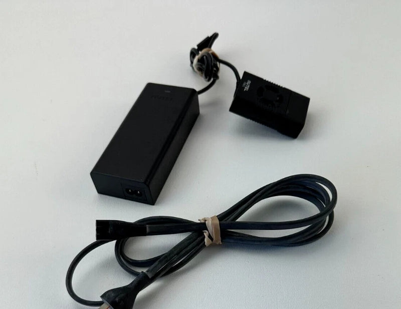 Black AC power adapter charger with attached cables and plug connector
