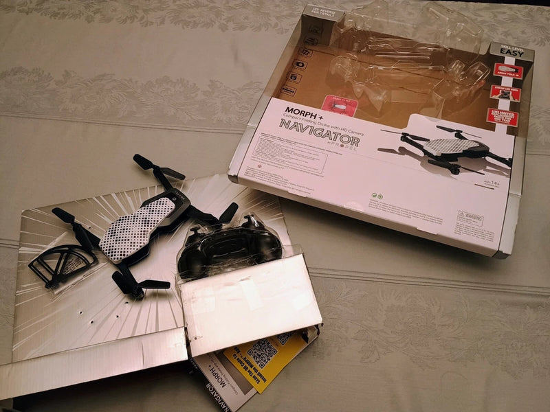 Foldable quadcopter drone with black body and four visible propellers
