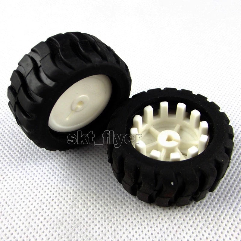 Pair of black model tire wheels with white plastic hub gears for DIY robot