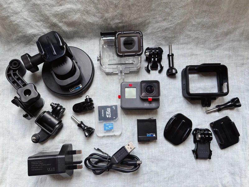 GoPro HERO6 Black action camera kit with waterproof housing, mounts, charger, and suction cup