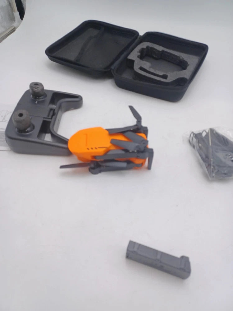 Orange quadcopter drone with gray arms, exposed body and included storage case