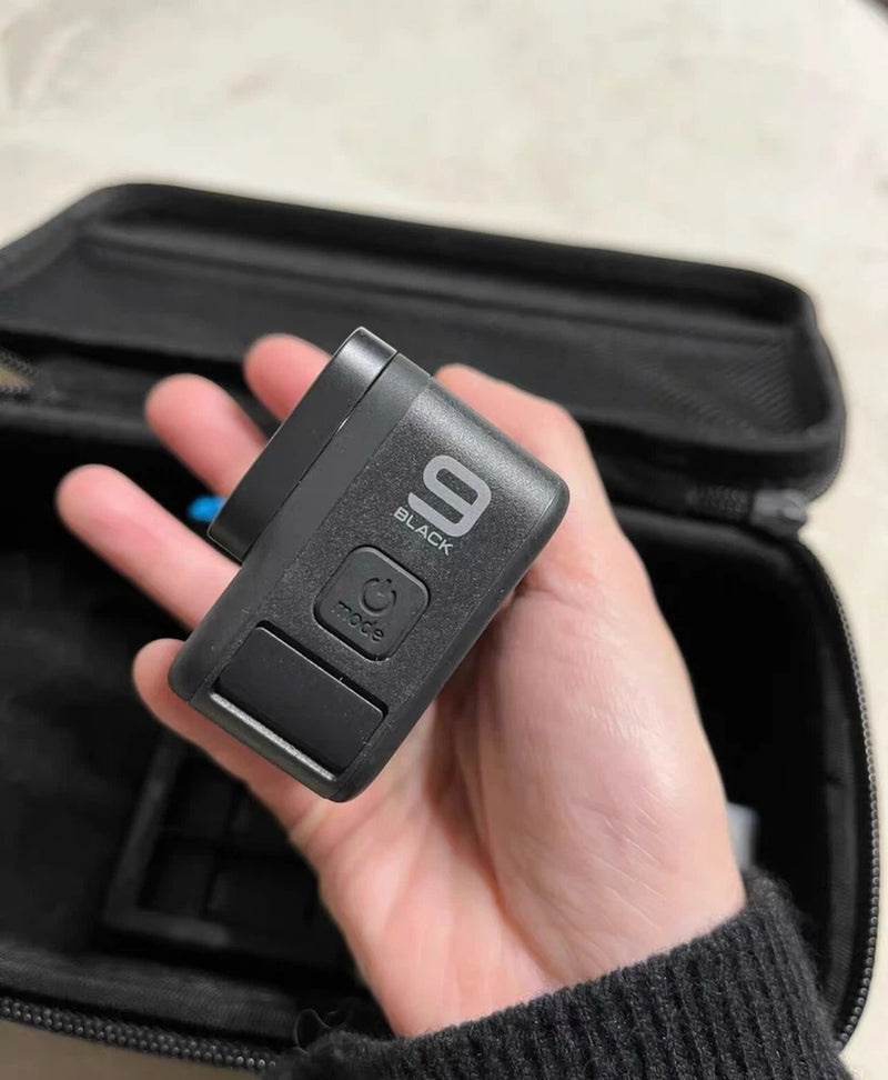 GoPro action camera back with Black label, held in hand