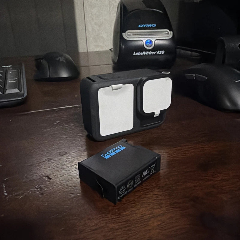 Black GoPro HERO13 action camera with white front cover and protective case
