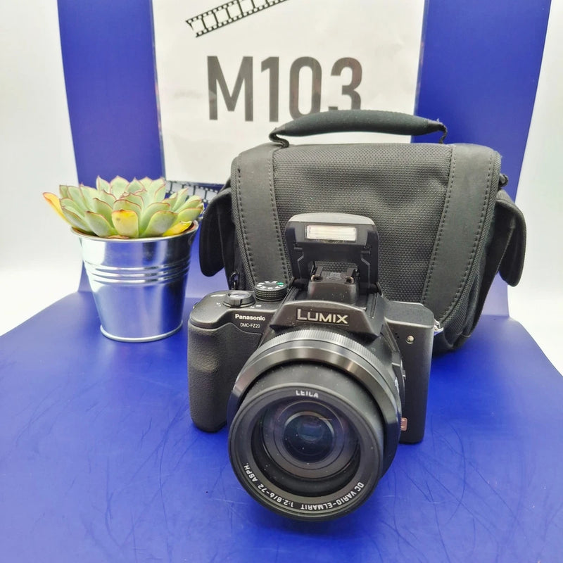 Panasonic LUMIX compact digital camera with lens and gray carrying case