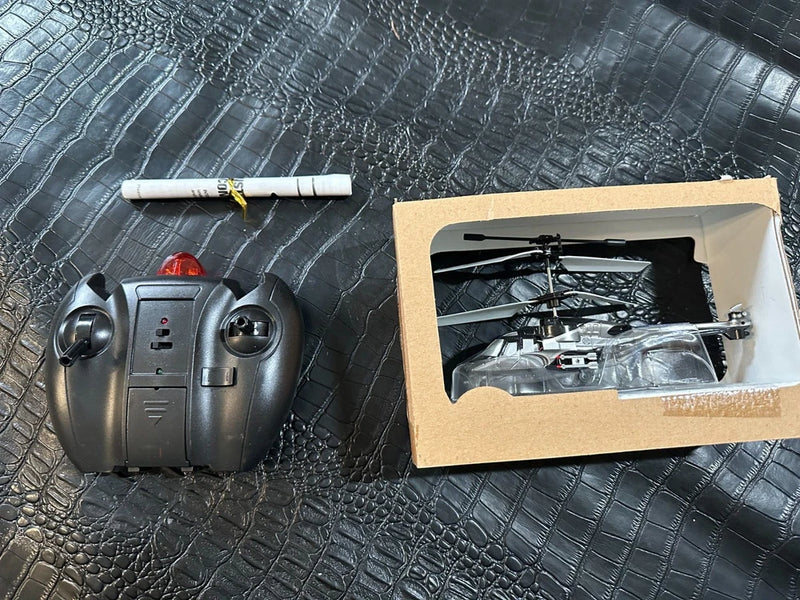 Vintage remote control toy helicopter set with gray controller and boxed helicopter