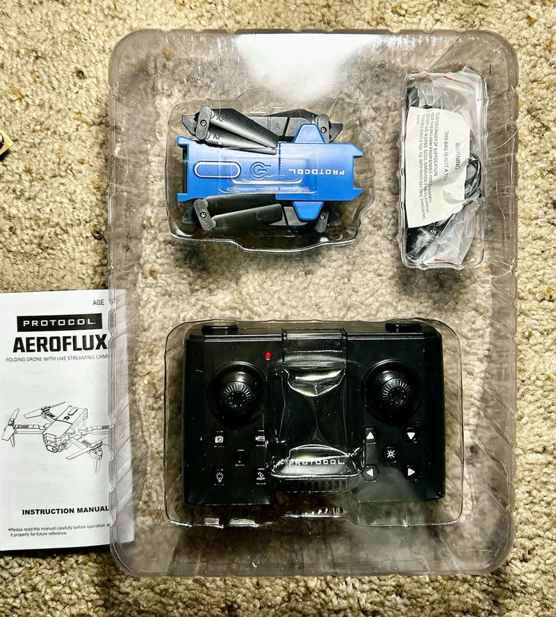 Protocol AeroFlux folding drone with camera, blue and black, in packaging with manual
