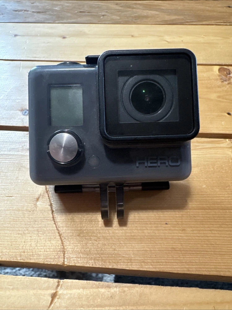Waterproof action camera with front lens, side screen, and HERO logo