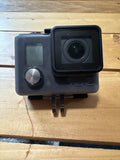 Waterproof action camera with front lens, side screen, and HERO logo