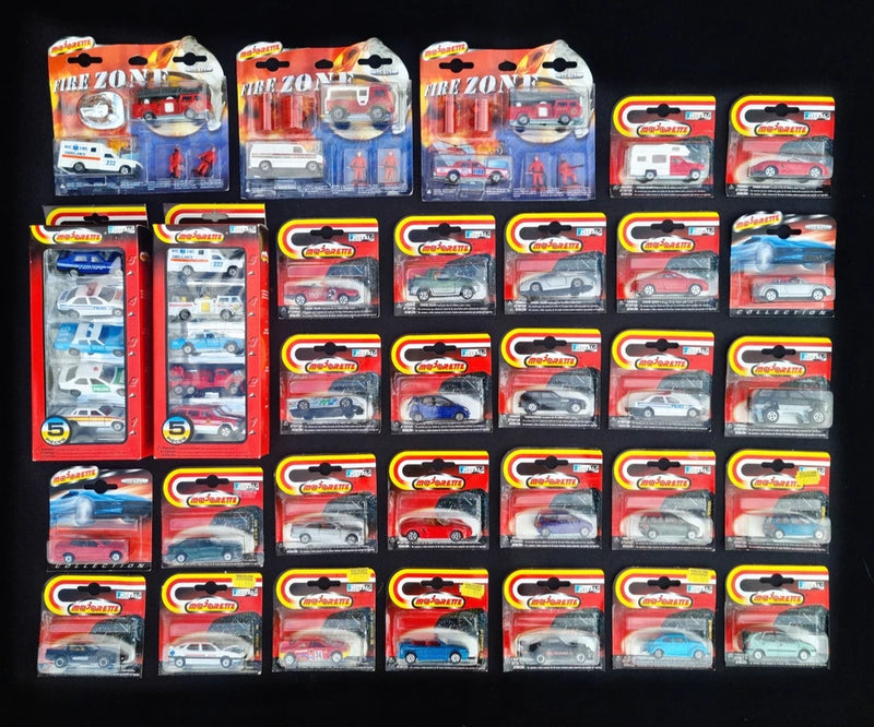 Toy model cars and trucks in blister packs, boxed set of assorted vehicles