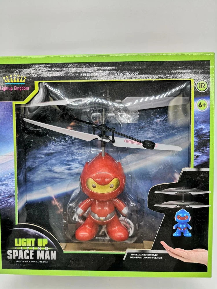Light-up red spaceman helicopter toy drone in retail packaging, IR sensor-controlled