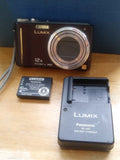 PANASONIC LUMIX  DMC-TZ7/with charger & 1 battery.FOR PARTS OR  REPAIR.