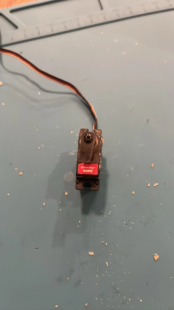 Nano RC servo motor with attached wiring and mounting bracket